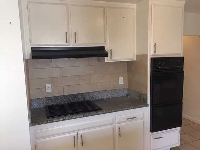 stove top, 2 wall ovens, granite countertop