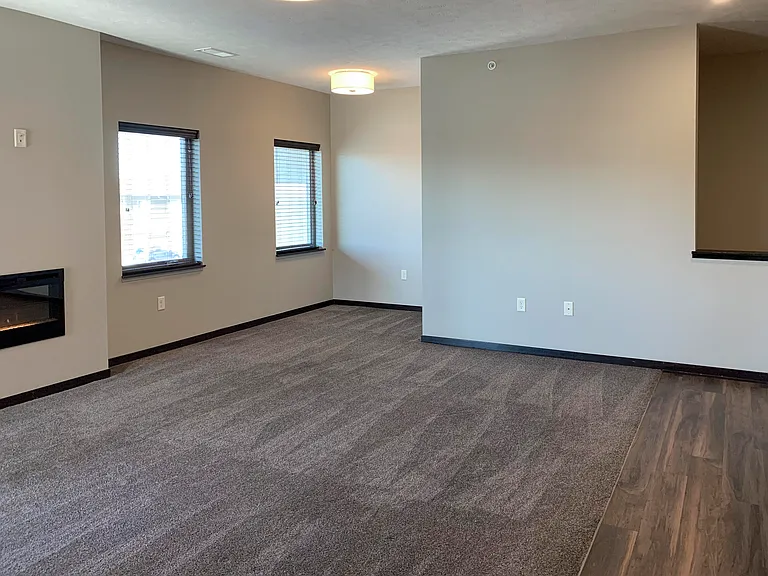 Our living rooms create a cozy retreat with a modern fireplace and natural light, perfect for relaxation.
