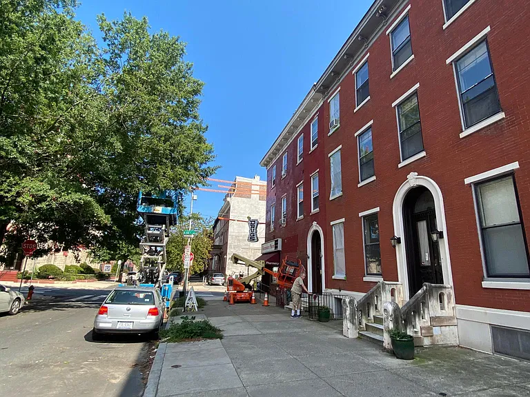 Tree line extra-wide sidewalk, Fairmount Pharmacy on the corner 19 Street. accept mail back packages
