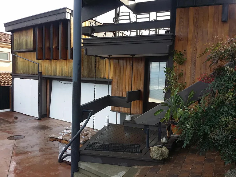Studio is over garages. This is parking area. Stairs going up to the right, lead to upper deck and private entrance.