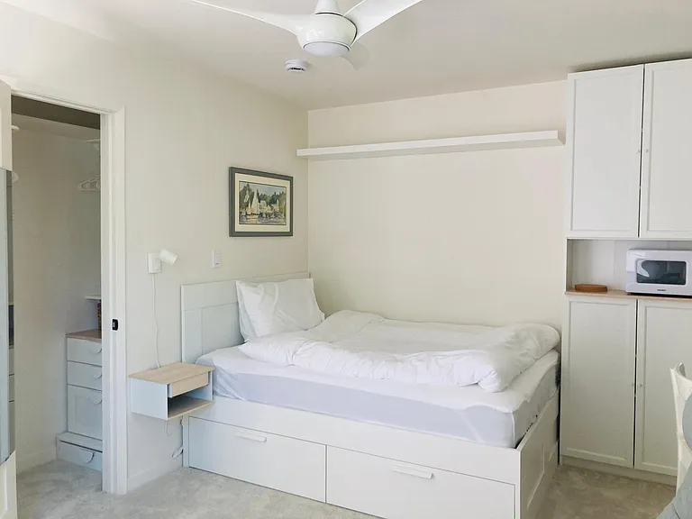 full bed with cotton linens, two drawers, nightstand, next to the closet with dresser