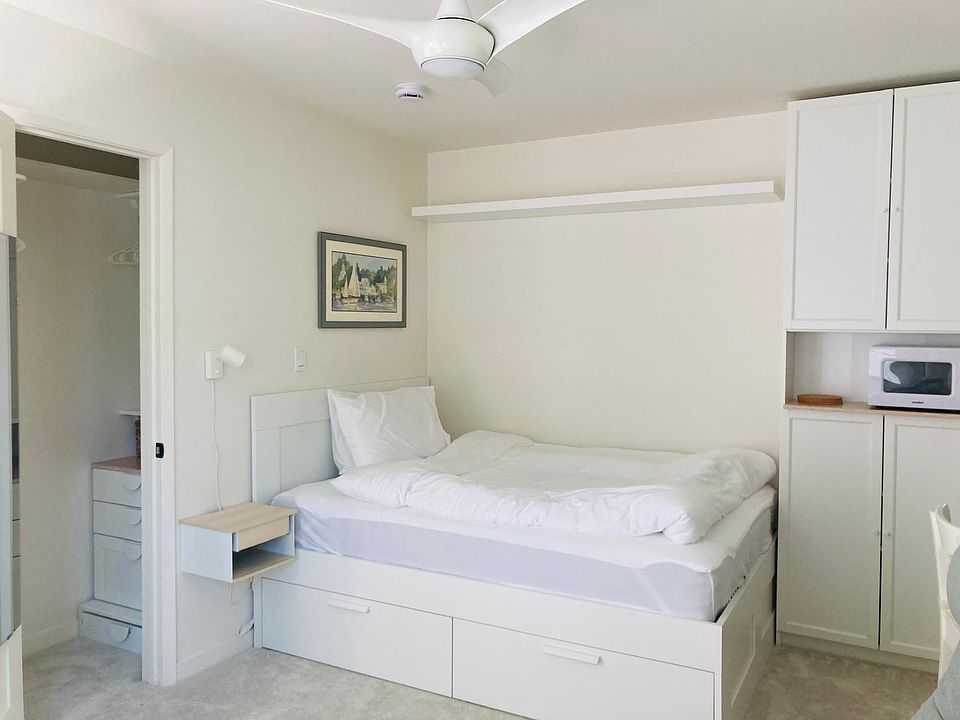 full bed with cotton linens, two drawers, nightstand, next to the closet with dresser