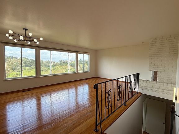 Living-dining space. Wood burning fireplace to the right.