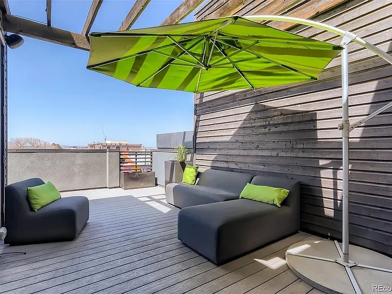 roof deck with additional space around the left (behind single chair)