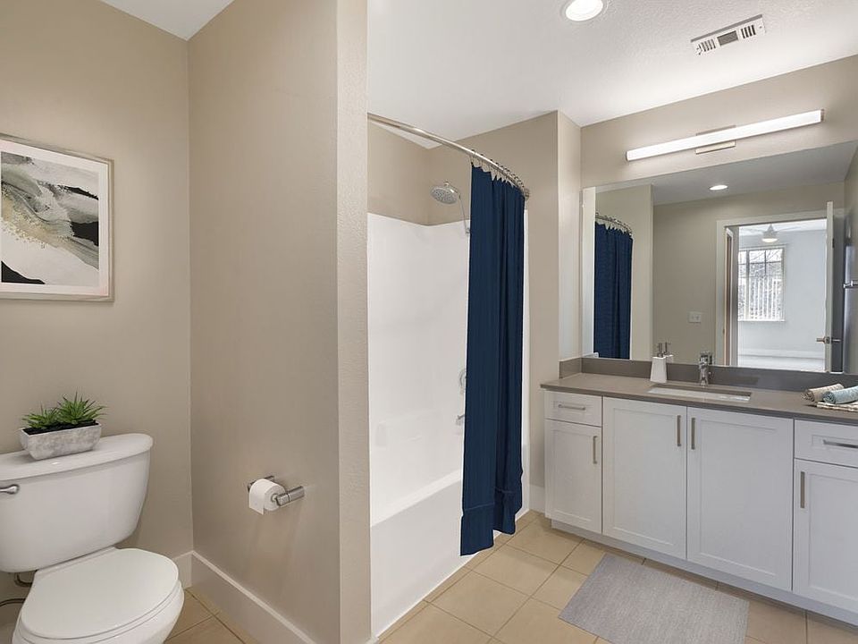 Renovated Package I bath with white cabinetry, grey quartz countertops, and hard surface flooring
