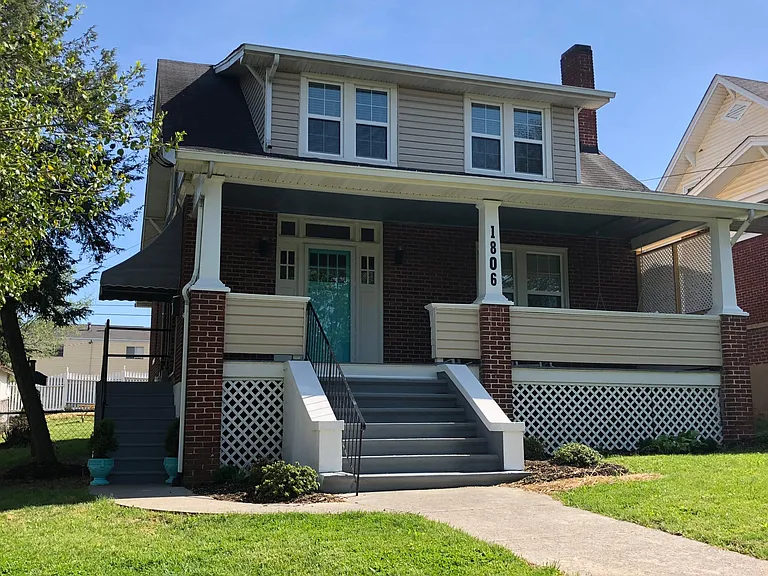 Front of house, entrance to upper duplex to the left
