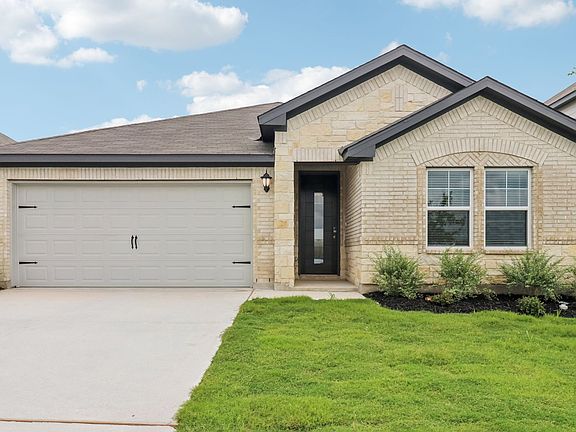 Front exterior of the Fitzhugh floorplan at a Meritage Homes community in San Antonio, TX.