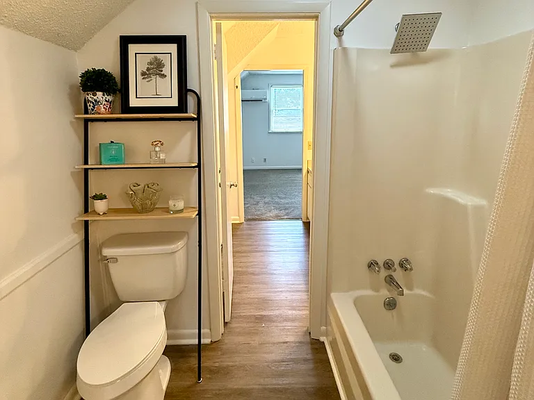 This is the wet area between the 2 vanity areas which include a tub shower and toilet. With a tub and shower you have your choice of using whatever is your preference. This is a quite roomy area with some extra standing area as you can see by the towel b