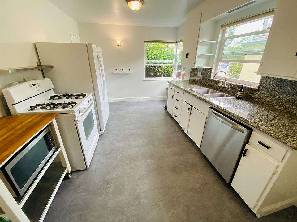 Spacious eat-in kitchen w/ dishwasher, gas stove, microwave, large fridge, and new flooring