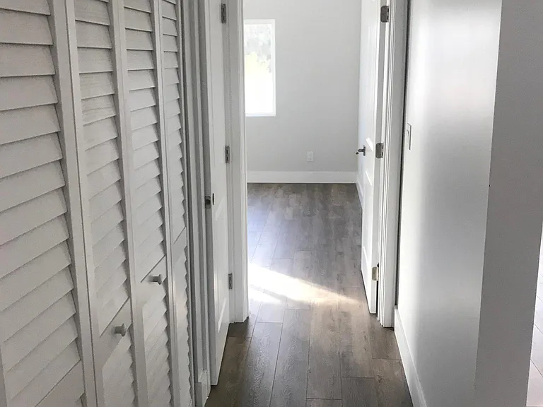 Hallway with access to laundry and linen closet