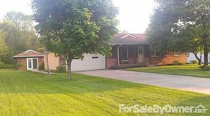 Front View from the streeet
						:
						Notice the woods behind the home and large trees in front. Keeps home very cool.