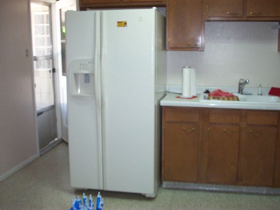 Newer Refrigerator and laundry room door to deck