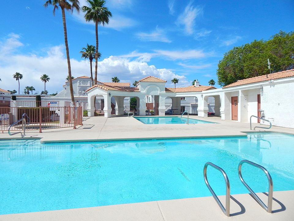 Fenced El Parque pool and patio area with 2 pools