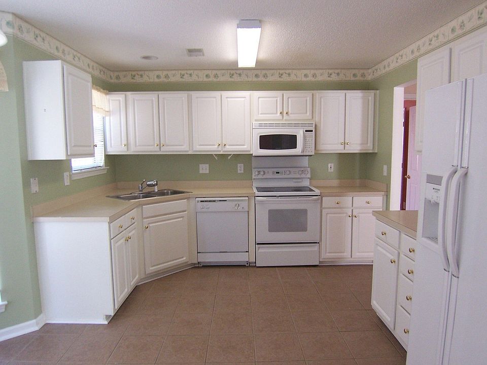 all white kitchen with all tiles