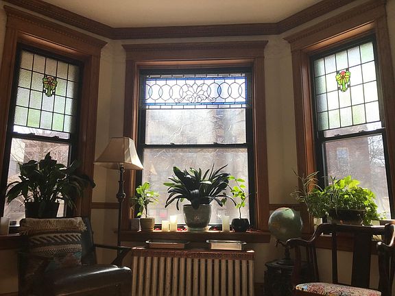 Front room with bay window and stained glass.