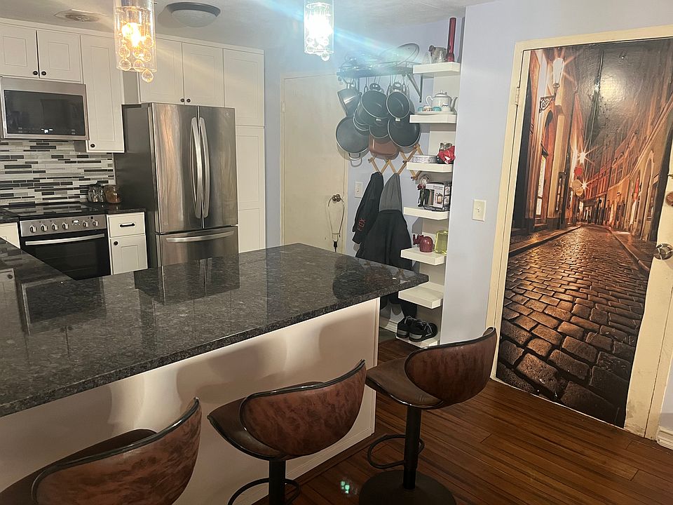 kitchen has plenty of storage, winetrack, two trash cans, shelves for hanging pots/pans and ceramic tile floors
