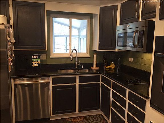 Updated kitchen with stainless appliances and slab granite counters.