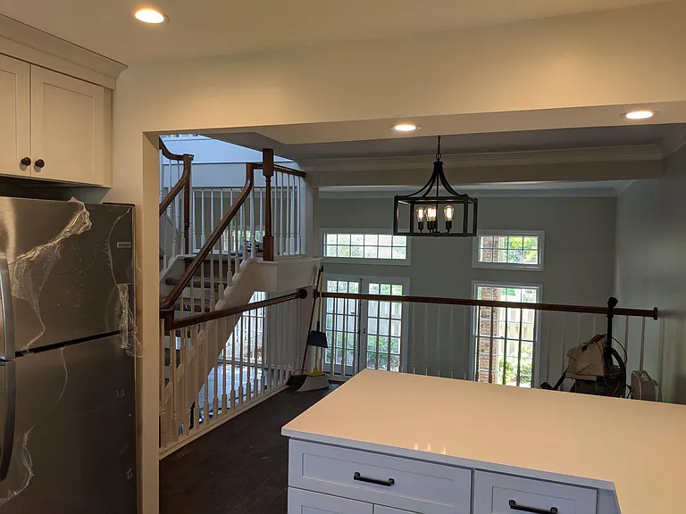Kitchen opens to dining room and living room beyond