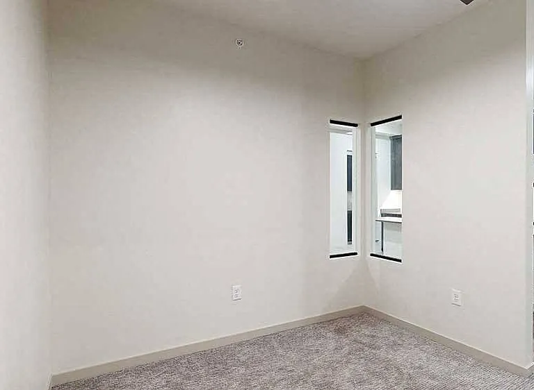 A sleeping area featuring a privacy wall and unique windows helps to create a cozy retreat in this Fox studio.
