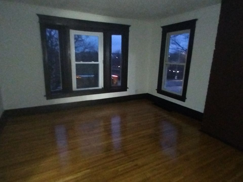 spacious living area, with refinished original hardwood flooring and large closet for storage