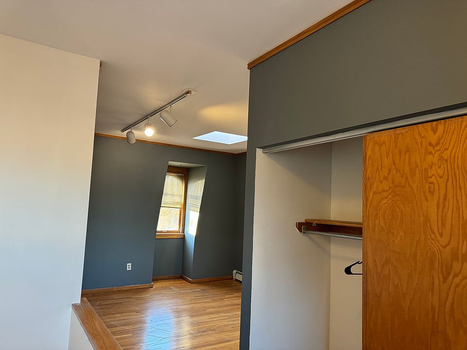 There is a built it in closet on the landing. The bedroom is bright and airy; it has many windows overlooking landscaped yard and there is a skylight also
