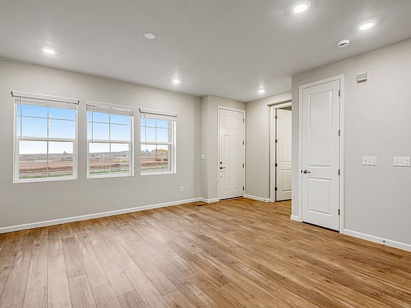 Bright and open great room with wide-plank laminate wood color floors