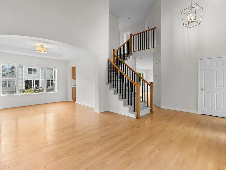 Freshly painted in a soft neutral palette that complements a variety of decor styles, with updated lighting throughout the first floor and a convenient coat closet for additional storage.