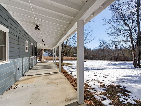Covered porch that faces south. Your private lawn is on the right .