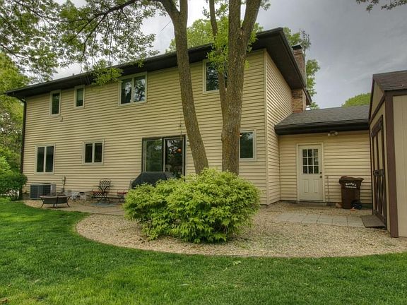 The back yard is large and offers a shed, a patio and mature trees.