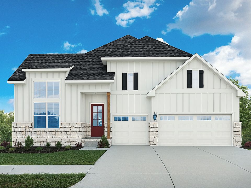 Exquisite white farmhouse with stone veneer, black shutters, and luxurious red door at Brush Creek.