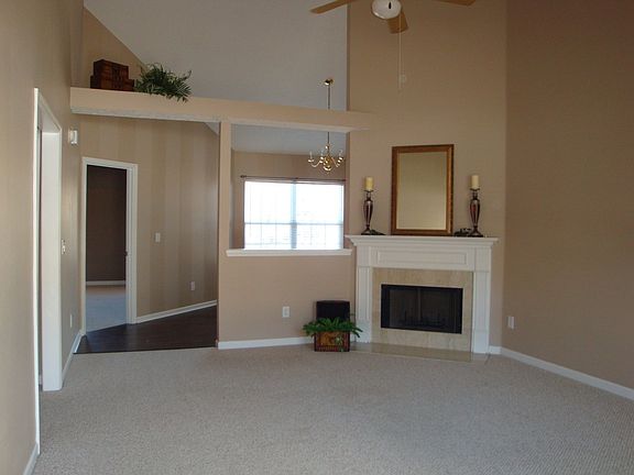 Great Room has gas fireplace, high ceilings, plant ledges & is open to dining 