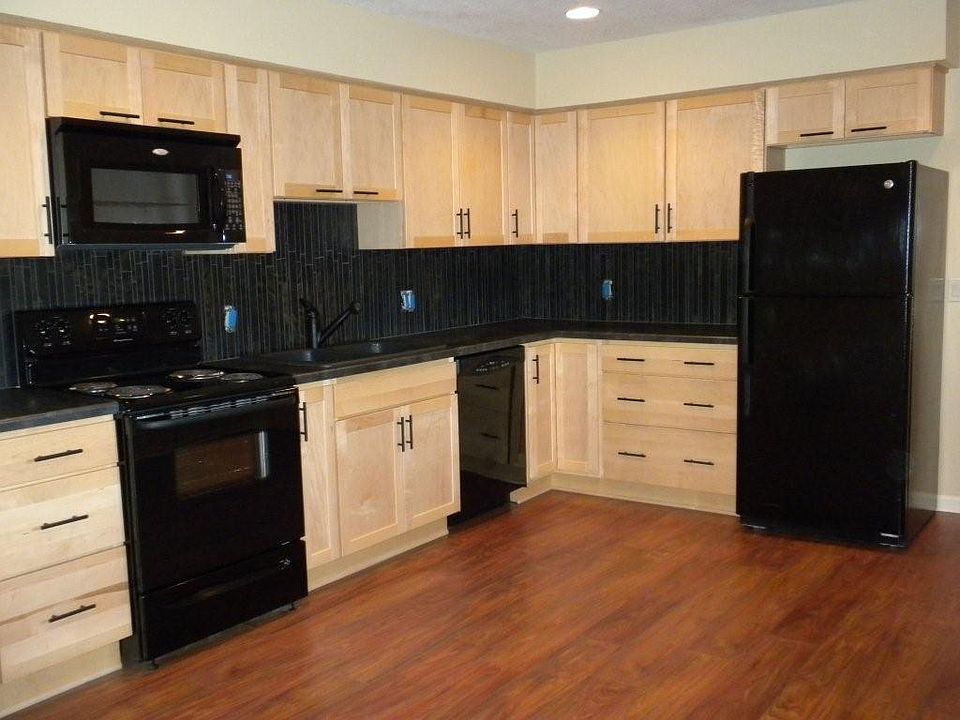 designer kitchen with black tile backsplash