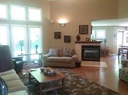 great room  w/ 12 foot ceilings and crown molding tandem widows with dual gas fireplace hardwood floors