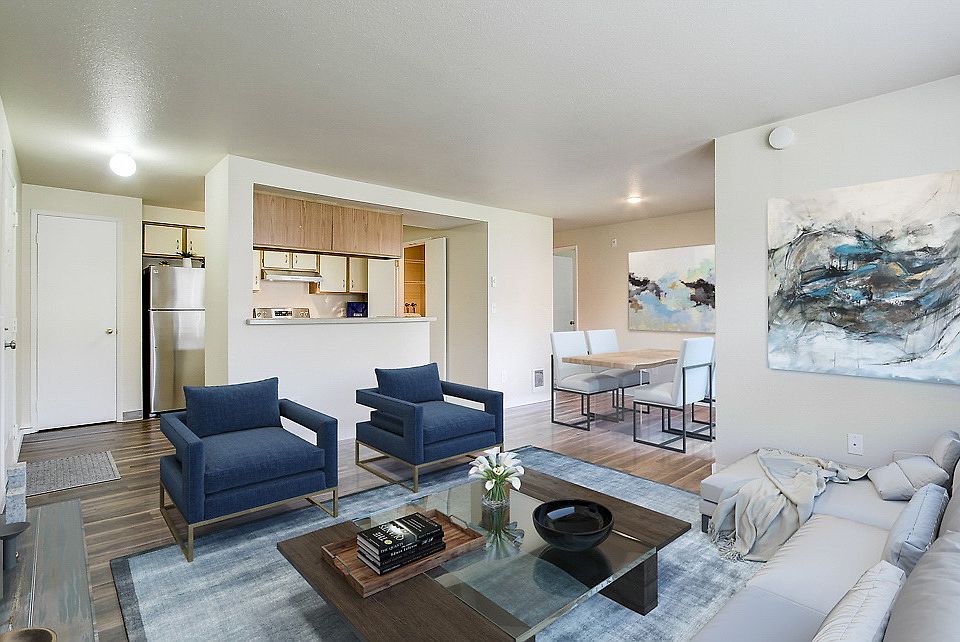 Staged living room with hardwood style vinyl flooring. Classic kitchen.