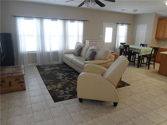 View of family room and breakfast nook well illuminated with sunlight.