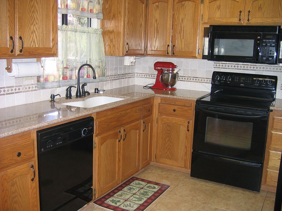 New engineered stone countertops with tumbled marble splash, Kohler sink
