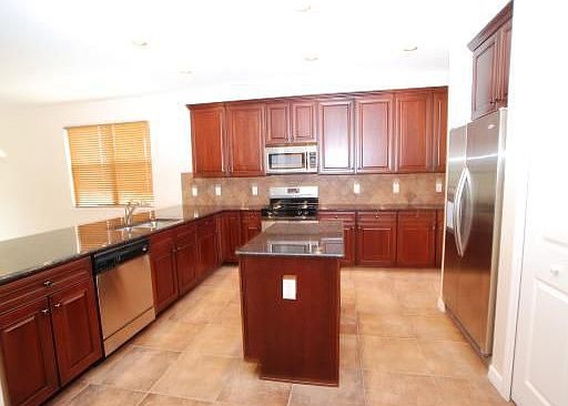 Kitchen with Gas Range and Island - Granite countertops and cherry cabinets