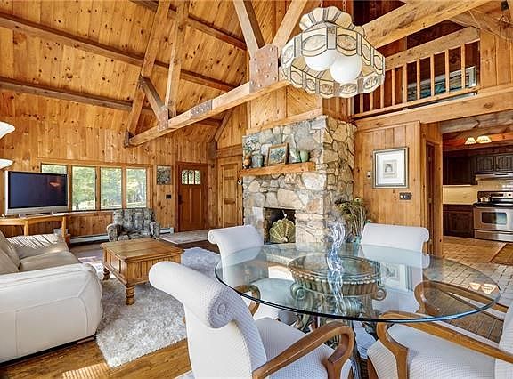 The Great Room with fieldstone fireplace features the Living Room and Dining Room; just outside the kitchen