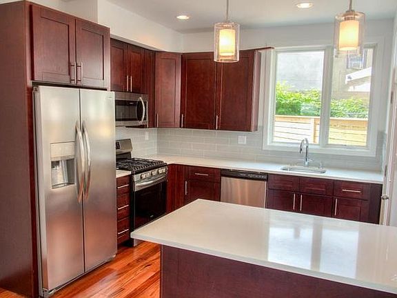 High-end, stainless steel Frigidaire appliances, gas range, quartz countertops. Large private, fenced-in patio off kitchen.