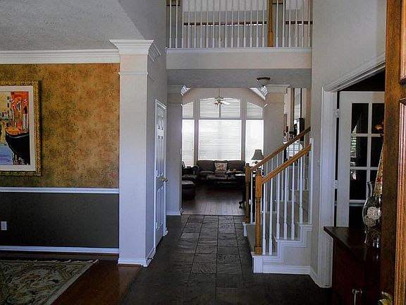 Two story foyer with slate tile floors. The formal dining room is on the left and the study with french doors is on the right.
