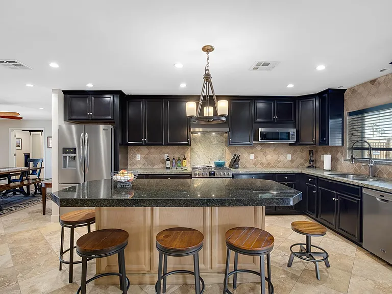 Beautiful kitchen features new gas range, microwave, refrigerator and dishwasher.