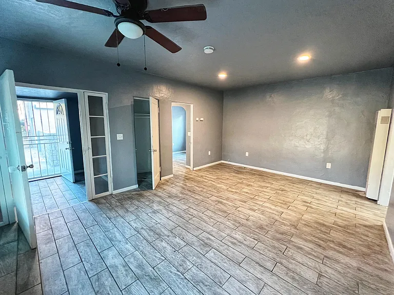 Living room with entrance to left and entrance to kitchen in the middle