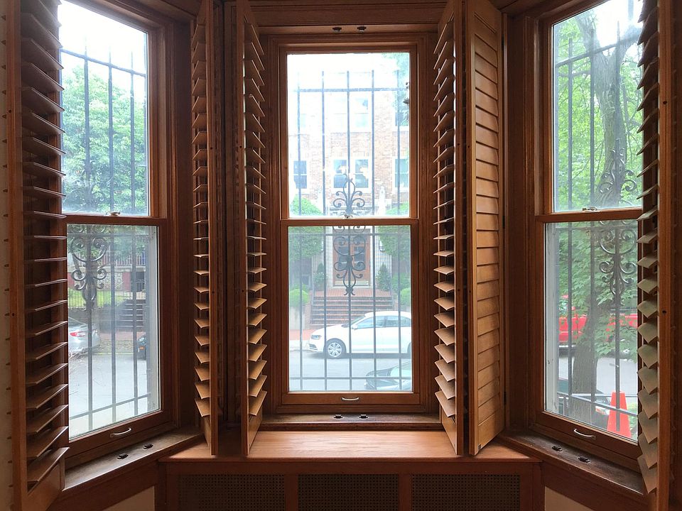 Parlor - three windows open to a quiet street.