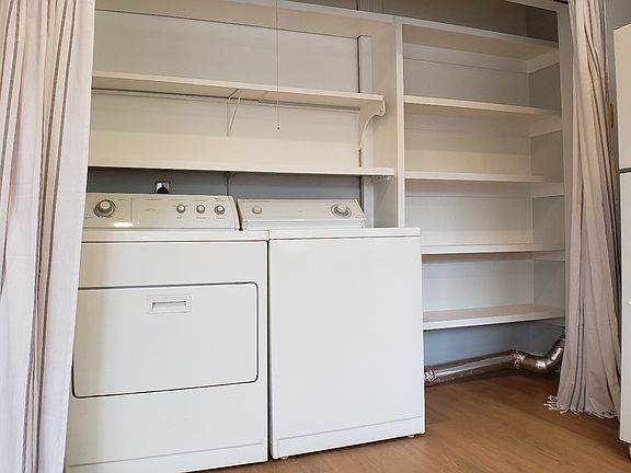 Laundry and pantry storage behind the soft curtains!