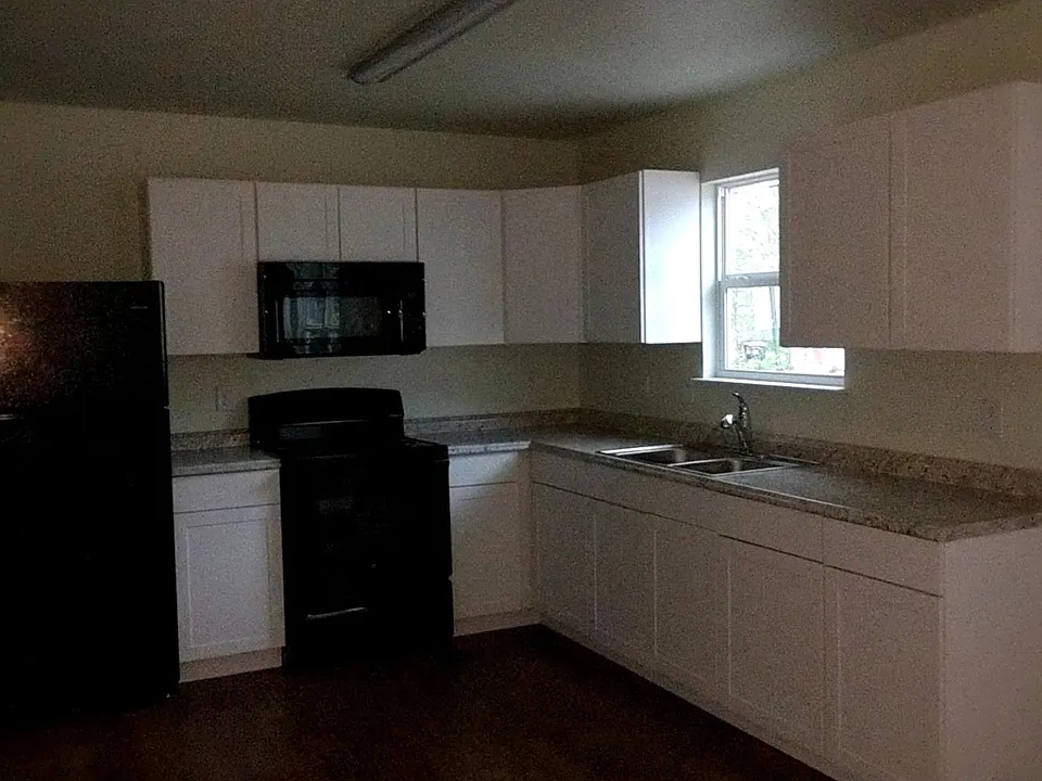 Kitchen complete with refrigerator, stove, microwave, and ga