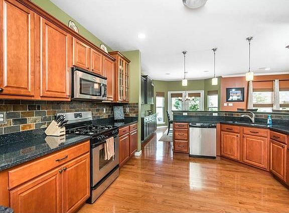 Stunning kitchen with 42" cabinets, stainless appliances, backsplash, and quartz counters.