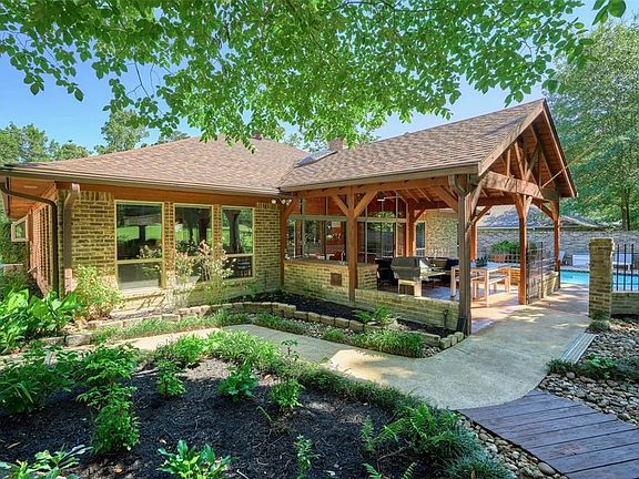 Enjoy the outdoors on your covered back porch with the outdoor kitchen and plenty of seating room.
