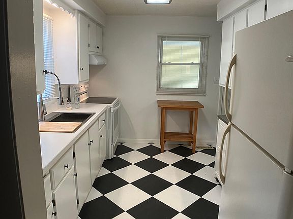 kitchen with new tile, sink, counter tops, range, outside vent, faucet, shelf liners, paint, LED lights; ready for a delicious meal