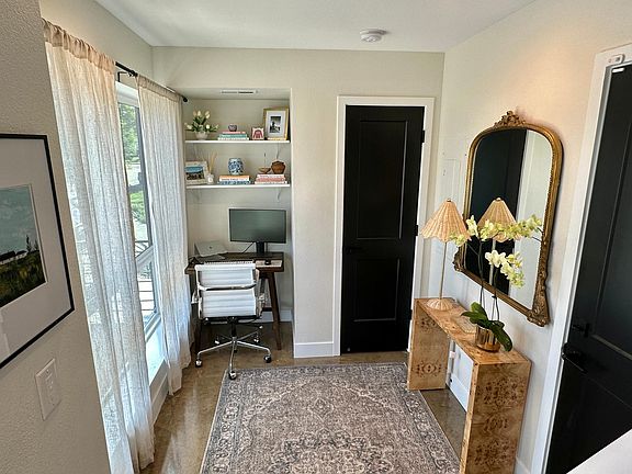 Entryway with office alcove, dimmable canned lights, coat closet, and door to access private garage