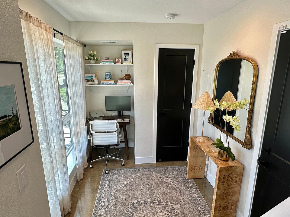 Entryway with office alcove, dimmable canned lights, coat closet, and door to access private garage